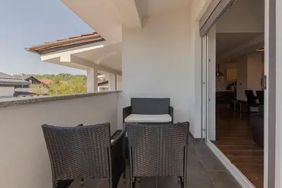 a balcony with three chairs and a chair on it at Frida's Place Ljubljana in Ljubljana
