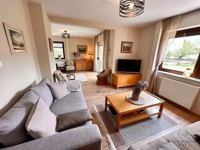 a living room with a couch and a table at Vila Minka Bled - Perfect Family Vacation Home in Bled
