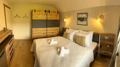 a bedroom with two white towels on a bed at Vila Minka Bled - Perfect Family Vacation Home in Bled