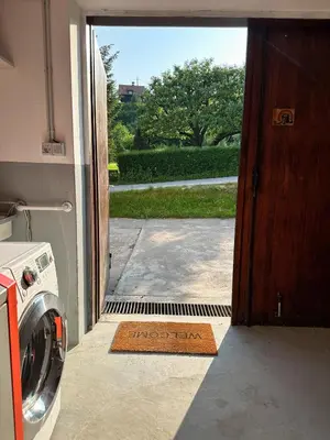 an open door to a house with a front yard at Nina's Place in Bled