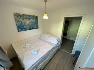 a bedroom with a bed with two slippers on it at Nina's Place in Bled