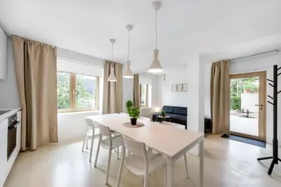 a kitchen and dining room with a white table and chairs at Modern holiday home with terrace close to Nova Gorica in Miren