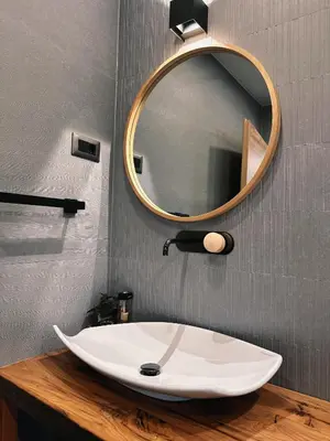 a bathroom with a white sink and a mirror at The Vila Bled Premium Luxury Retreat in Bled