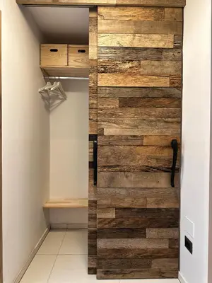 a wall of reclaimed wood in a closet at The Vila Bled Premium Luxury Retreat in Bled