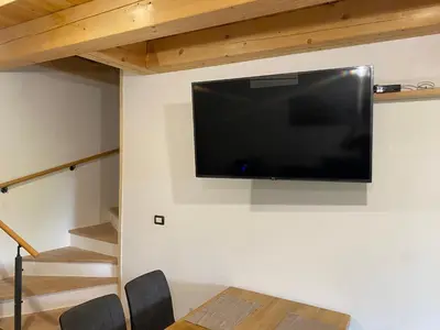 a flat screen tv hanging on a wall at Posestvo Tmžek in Bovec
