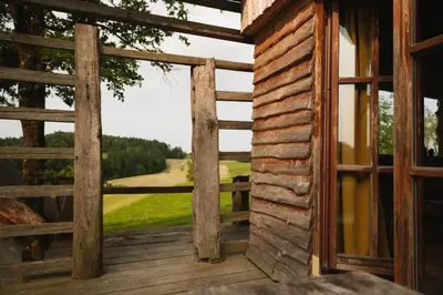 an open door to a porch with a view of a golf course at Ladybug Eco House in Gradišče pri Lukovici