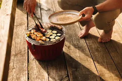 a person cooking food in a pot on a table at Ladybug Eco House in Gradišče pri Lukovici