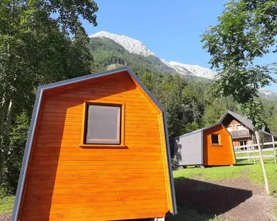 an orange and orange house in a field at Camping & Glamping Grintovec in Preddvor