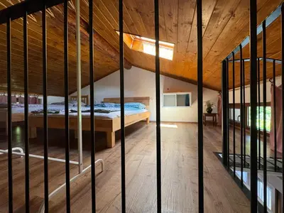 a bedroom with a bed in a room with wooden ceilings at Pri Piskovih in Grgar