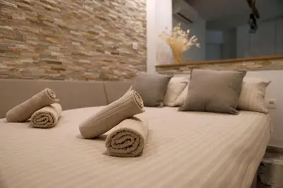 a bed with towels and pillows on it at Esti’s Oasis in Ljubljana
