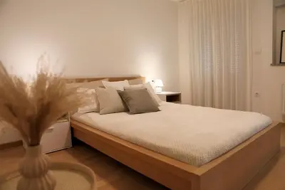 a bedroom with a bed with a vase on the floor at Esti’s Oasis in Ljubljana