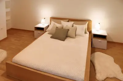 a bedroom with a large bed with two night stands at Esti’s Oasis in Ljubljana
