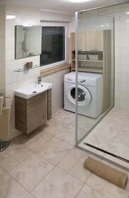 a bathroom with a washing machine and a sink at Esti’s Oasis in Ljubljana