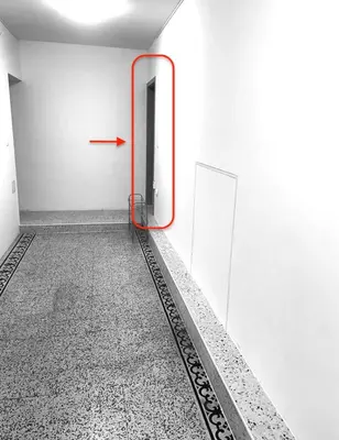an empty room with a red arrow on the wall at Lorume in Postojna