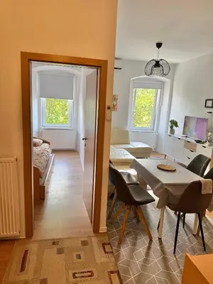 a living room with a table and a couch at Lorume in Postojna