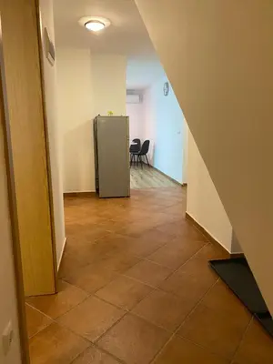 an empty hallway with a refrigerator in a room at Ada Apartment in Ljubljana