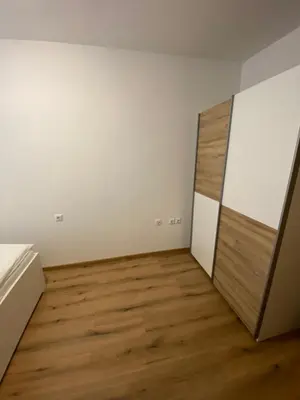 a room with white walls and a wooden floor at Ada Apartment in Ljubljana