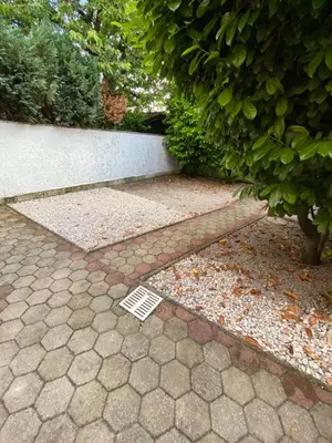 a vent on the ground next to a sidewalk at Ada Apartment in Ljubljana
