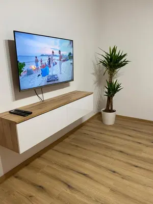 a living room with a flat screen tv on a wall at Ada Apartment in Ljubljana