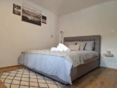 a bedroom with a bed with pillows on it at Greg's Rooms in Ilirska Bistrica