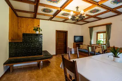a living room with a table and a couch at Traditional homestead Guhar in Radovna in Mojstrana