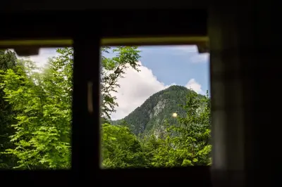 a view of a mountain through a window at Traditional homestead Guhar in Radovna in Mojstrana