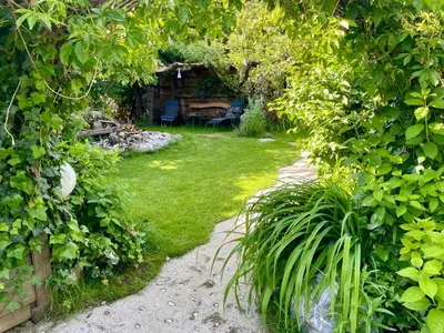 a garden with a table and chairs in the distance at Apartma Zeus in Jesenice