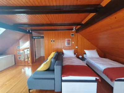 a room with two beds and a couch at Apartment Sonata in Kamnik