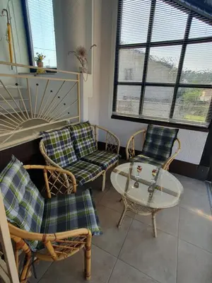 a living room with chairs and a table and windows at Apartment Sonata in Kamnik