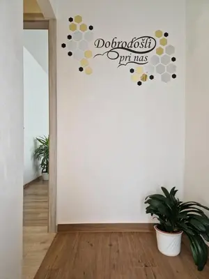 a room with a wall with a do not disturb sign on it at Medeni Apartma in Pivka
