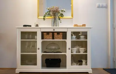 a white cabinet with a vase on top of it at Jane's Place, experience the atmosphere of a historic villa & free parking in Ljubljana