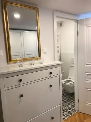 a bathroom with a white dresser with a mirror and a toilet at Jane's Place, experience the atmosphere of a historic villa & free parking in Ljubljana