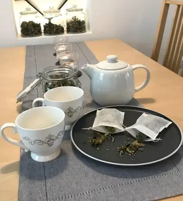 a table with a tea pot and a plate and cups at Jane's Place, experience the atmosphere of a historic villa & free parking in Ljubljana