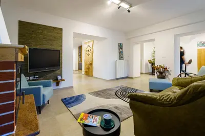 a living room with a couch and a tv at Guest House Žerjal in Podnanos