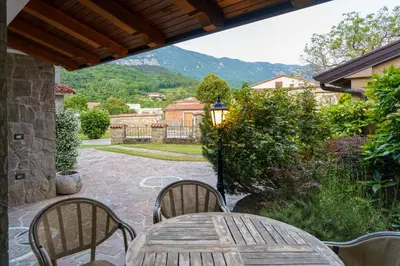 a table and chairs on a patio with a view at Guest House Žerjal in Podnanos