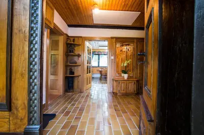 a hallway of a house with a tiled floor at Estate Žagmeštri in Ljubno