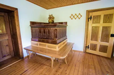 a wooden organ in a room with two doors at Estate Žagmeštri in Ljubno