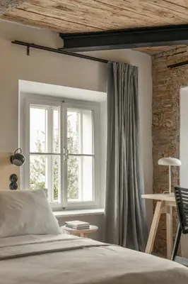 a bedroom with a bed and a window at April1550 Boutique Hotel in Ljubljana