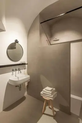 a bathroom with a sink and a mirror and a shower at April1550 Boutique Hotel in Ljubljana