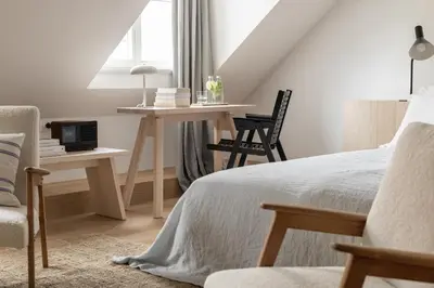 a bedroom with a bed and a desk and a chair at April1550 Boutique Hotel in Ljubljana