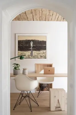 a white office with a desk and a chair at April1550 Boutique Hotel in Ljubljana