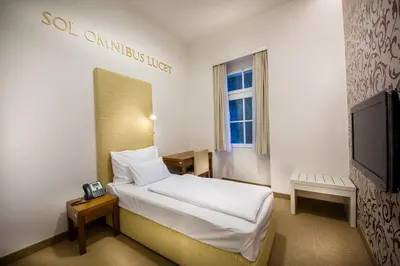 a hotel room with a bed and a tv at Rimske Terme Resort - Hotel Sofijin dvor in Rimske Toplice