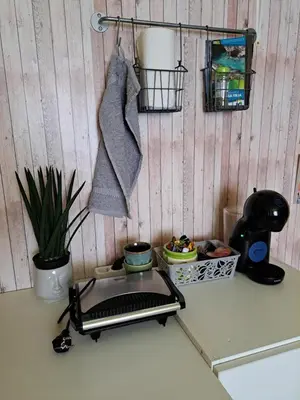 a kitchen counter with a stove with a pot and a towel at Ozy's place in Kamnik