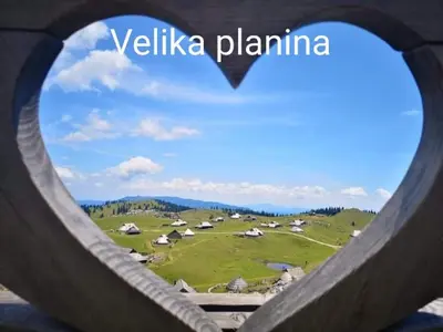 a view of a field through a heart shaped fence at Ozy's place in Kamnik