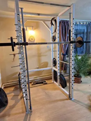 a room with a gym with a barbell and weights at Ozy's place in Kamnik