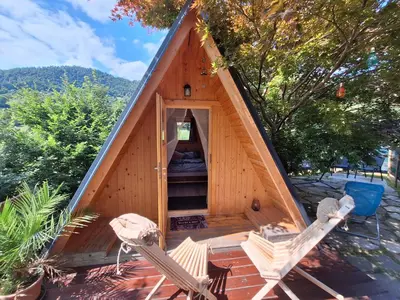 a dog house with two chairs in front of it at Ozy's place in Kamnik