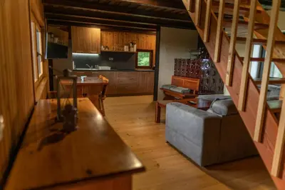 a living room with a couch and stairs in a house at VILA HELENA in Velenje