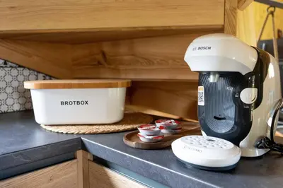 a kitchen counter with a mixer and a container at A Nest Under the Karawanks in Žirovnica