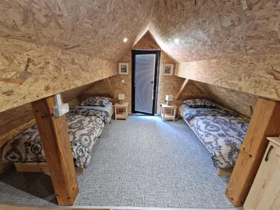 a room with two beds in a log cabin at Vineyard cottage Vinska grajska kašča in Mirna