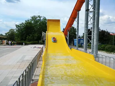 a yellow slide at a water park at Spa House Alenka Terme Čatež in Čatež ob Savi